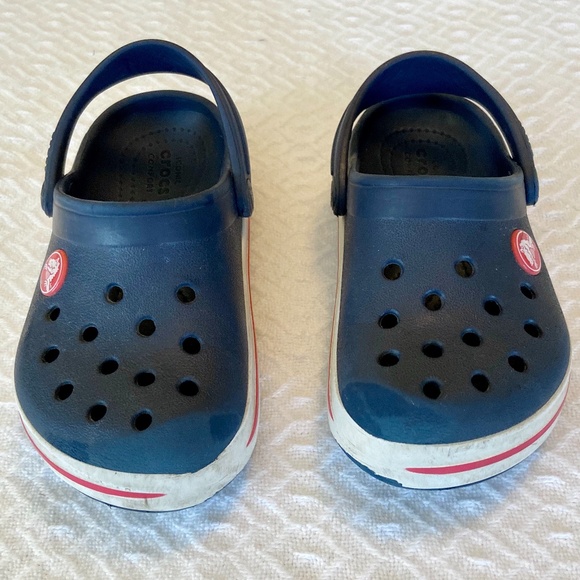 blue crocs with red stripe